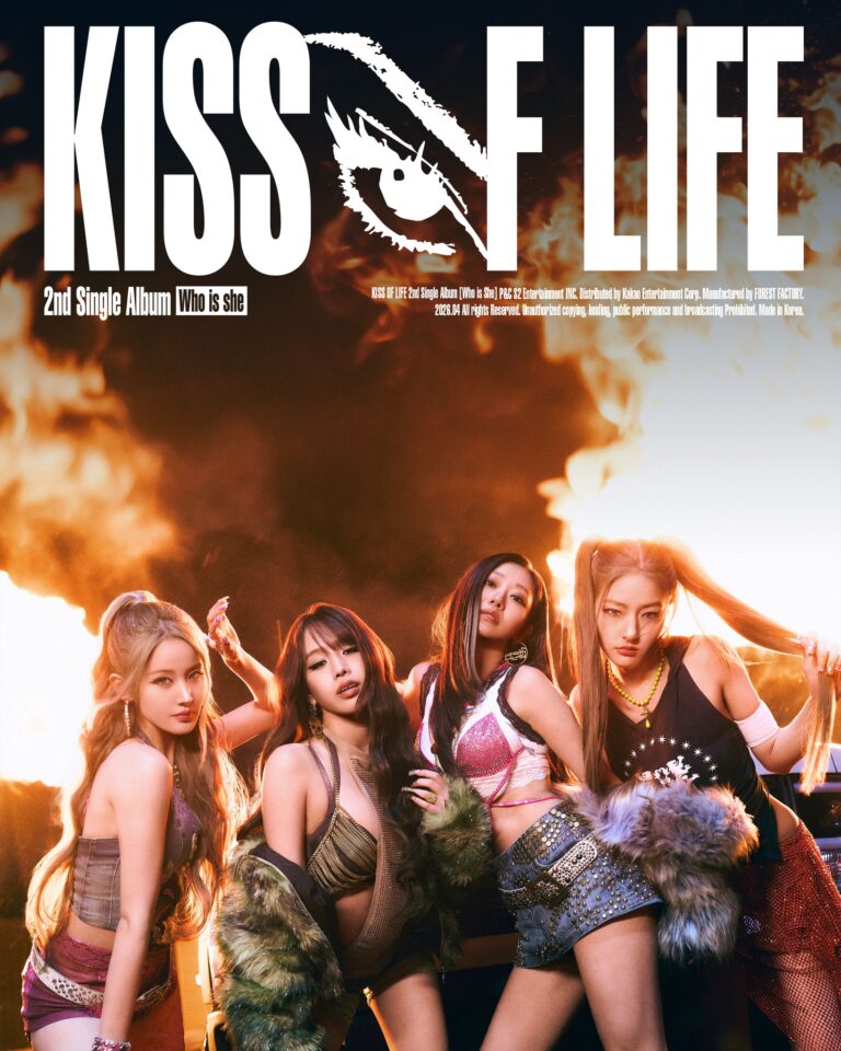 KISS OF LIFE members posing in front of a fiery background for the ‘Who is she’ 2nd single album promotional poster, wearing bold metallic and fur‑accented outfits.