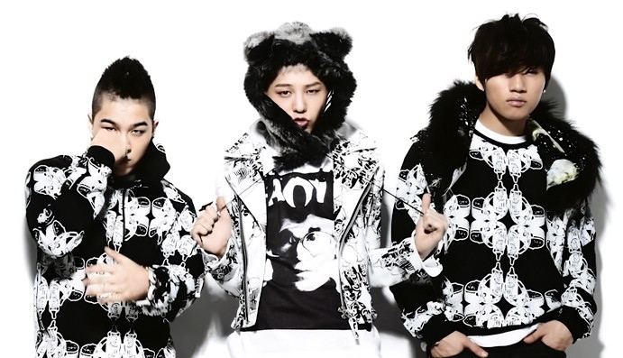 BIGBANG members displaying their individual styles in a unified group photo.