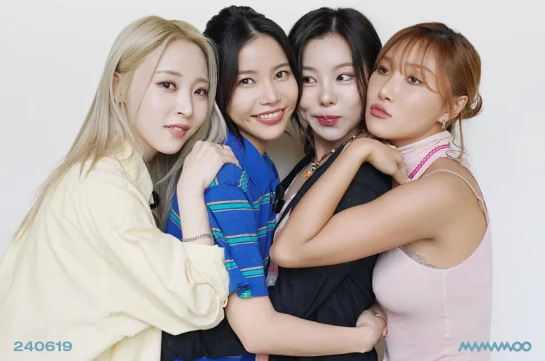 Group photo of MAMAMOO against a white background, showing the four members standing closely with arms around each other, each wearing different pastel and denim outfits. The image includes the text ‘240619’ and ‘MAMAMOO,’ highlighting the group’s branding and promotional concept.