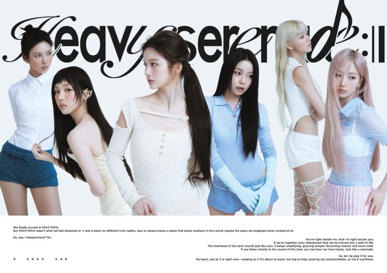 Promotional group photo of NMIXX’s six members standing in front of the ‘Heavy Serenade’ backdrop, wearing pastel-toned modern outfits with an artistic and dreamy concept, highlighting the group’s storytelling visual style.