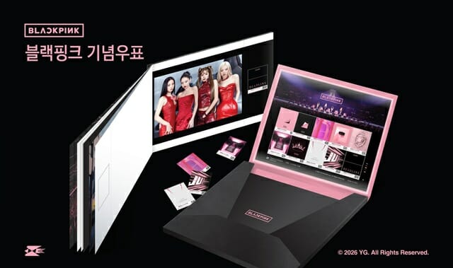 BLACKPINK commemorative stamp collection displayed in an open premium box, featuring photo cards, booklet pages, and official group images in a black‑and‑pink design